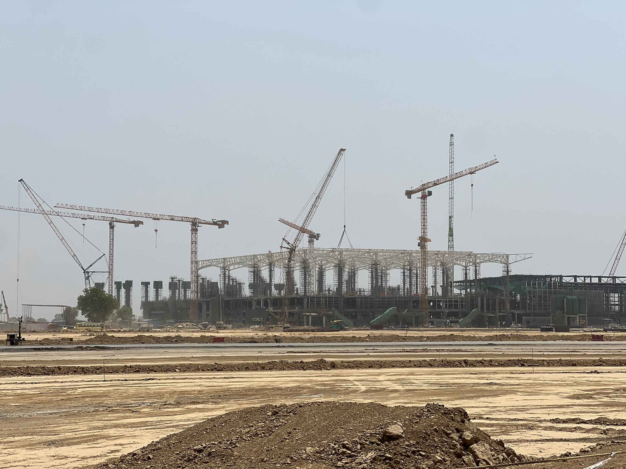 Photo of the terminal under construction at the planned Noida Airport in Greater Delhi in 2024, showing a spacious, open structure. The building shows the first architectural structures such as walls and ceilings.