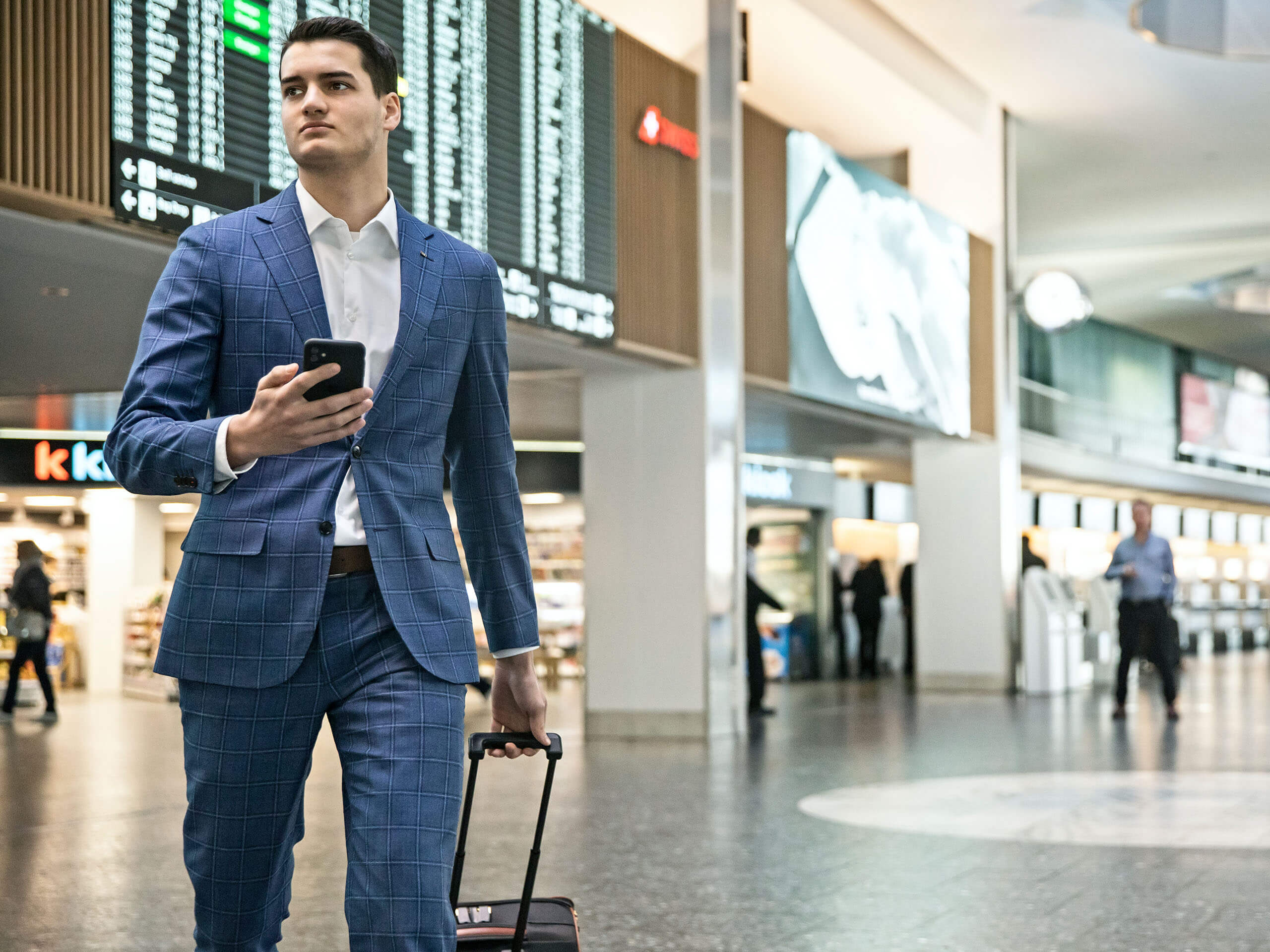 Man at the airport with mobile phone